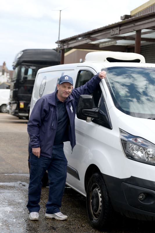 A Bodiam Foods driver next to a delivery van at the depot